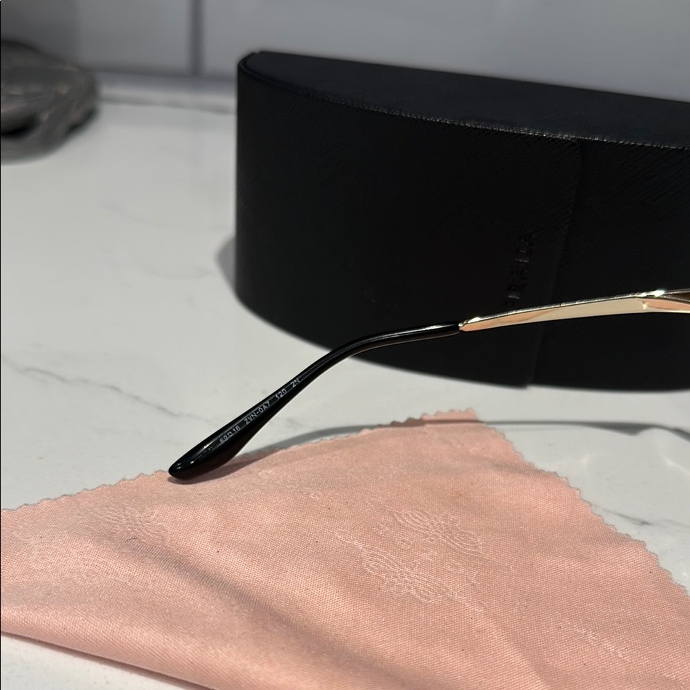 Prada PR74VS sunglasses butterfly silhouette with a metallic gold frame. - Picture 6 of 12